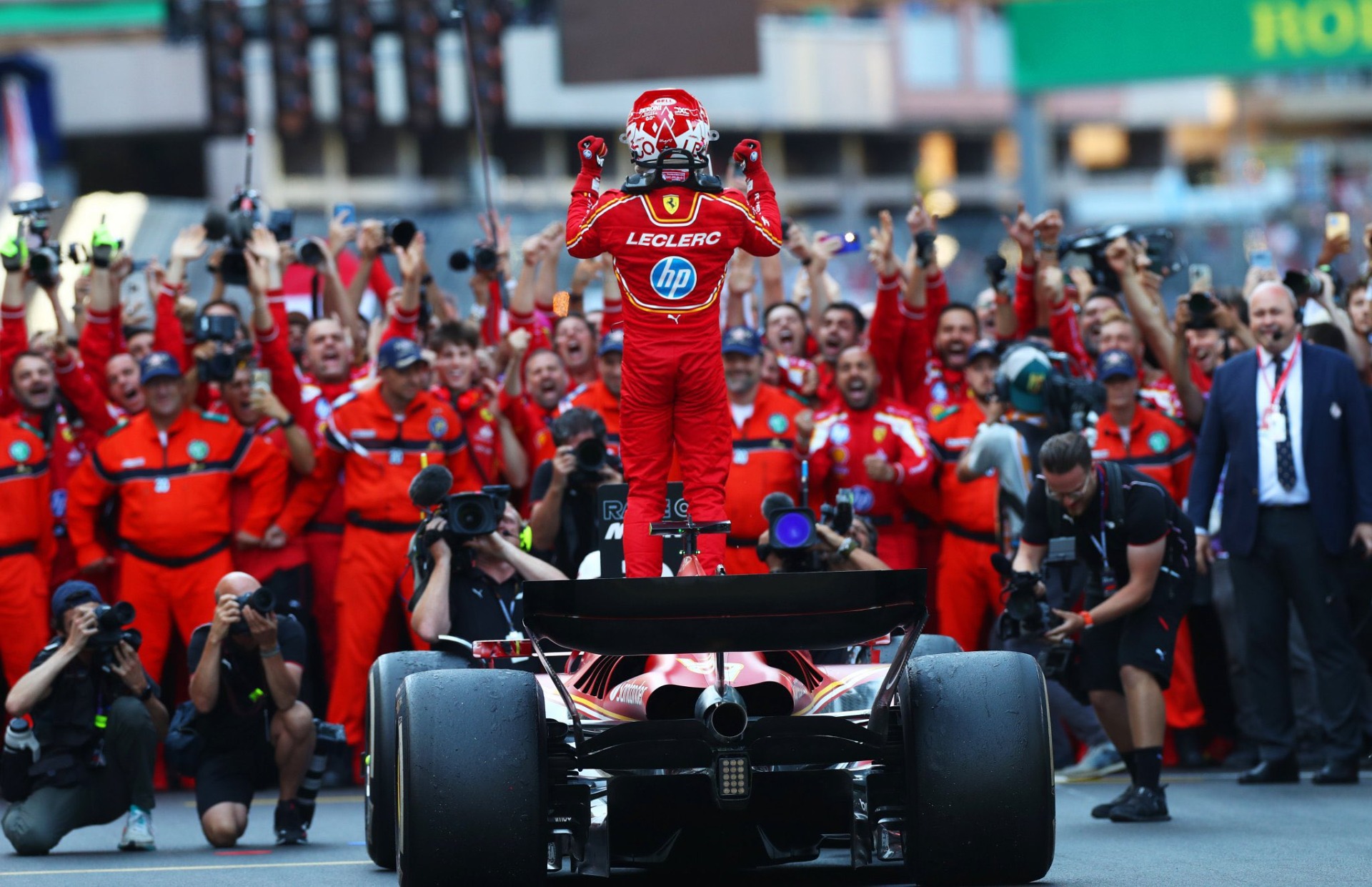 charles celebrating with his team and the marshalls after crossing the line  